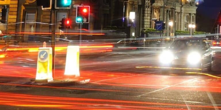 Road with car driving at night