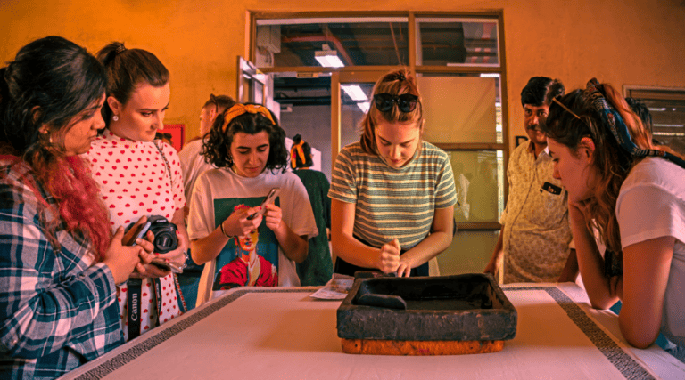 Students looking at an artefact on a table