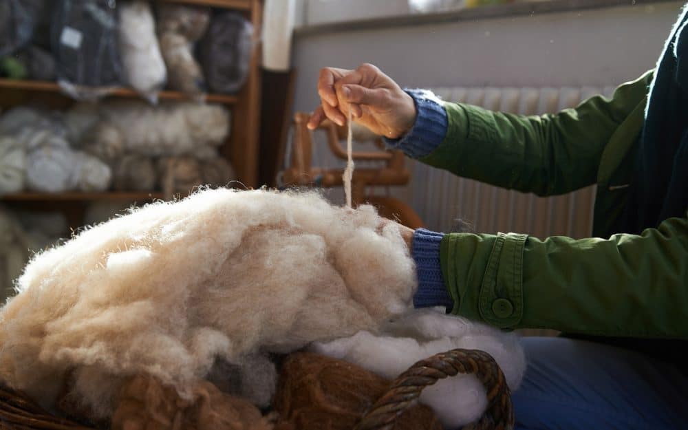 Image of hand picking on wool