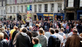 Crowd of tourists standing in Edinburgh's Royal Mile