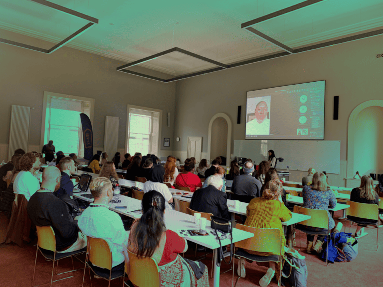 Students watching presenter in hybrid conference