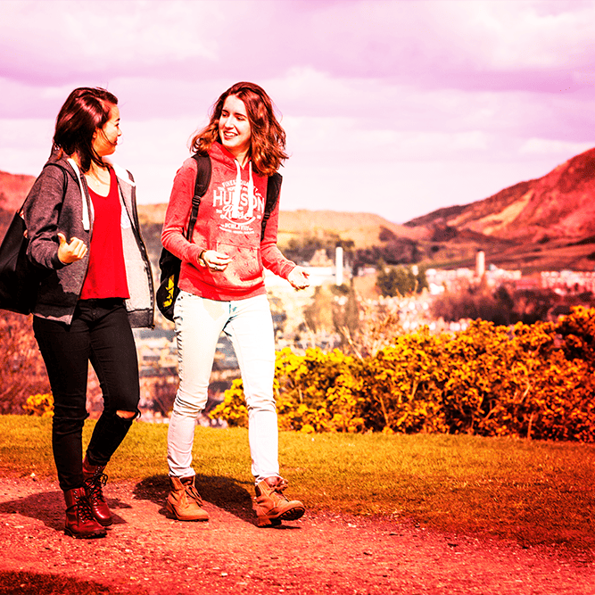 two people walking together on arthurs seat, edinburgh