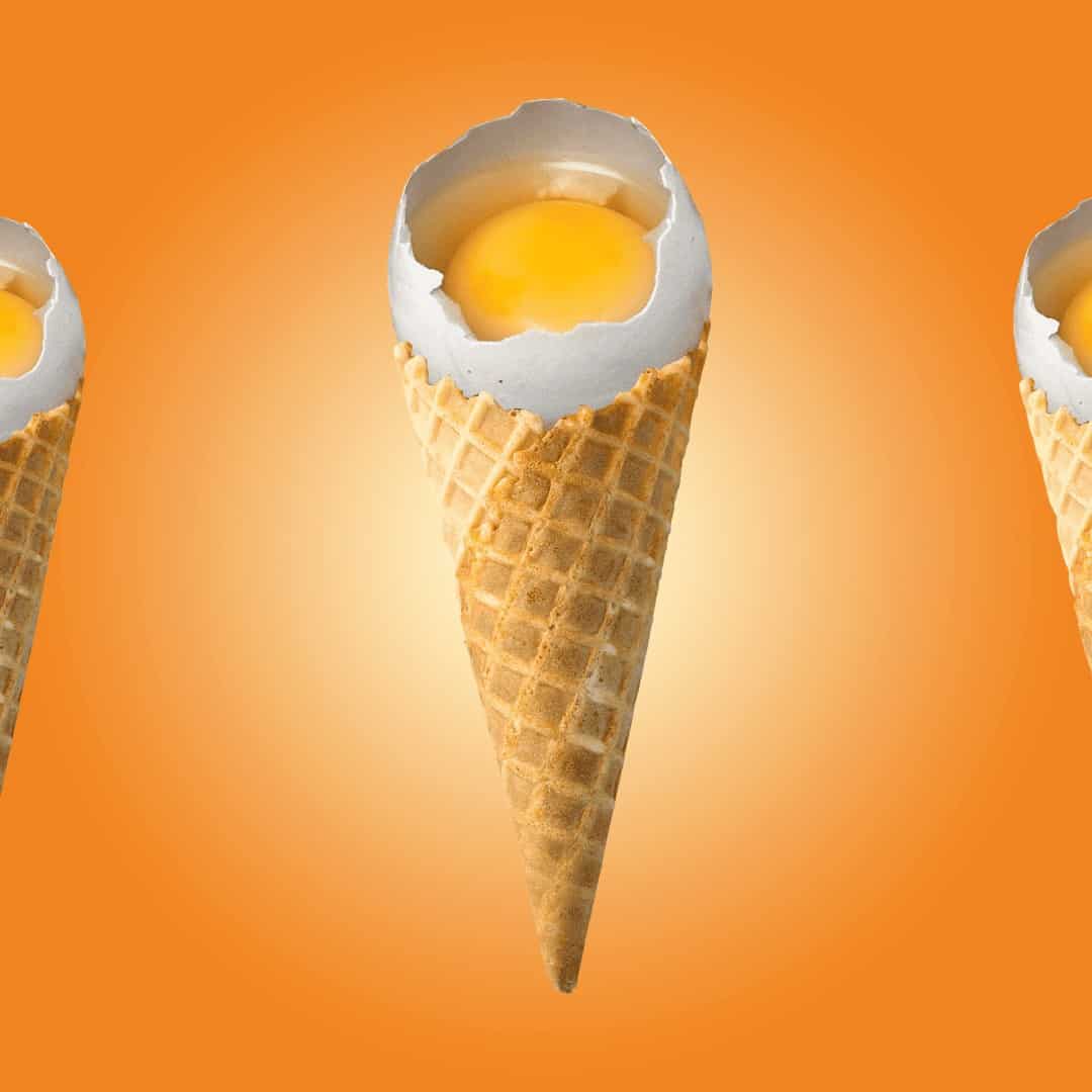 Ice cream cones containing egg yolks on orange gradient background