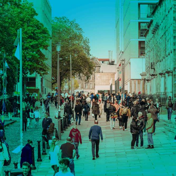 Lots of people waking across Edinburgh University's main campus, green tint over image.