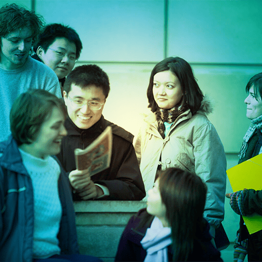 A group of undergraduate students outside a building, green tint over image.