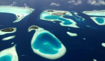 Panoramic view of Maldives islands from sea plane. Photography by Martin Kovalenkov