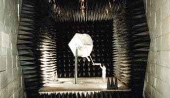 Fred Domer makes an adjustment to the position of a unit before it is tested in an anechoic chamber in the Payload Checkout Facility at the Naval Research Laboratory (NRL).