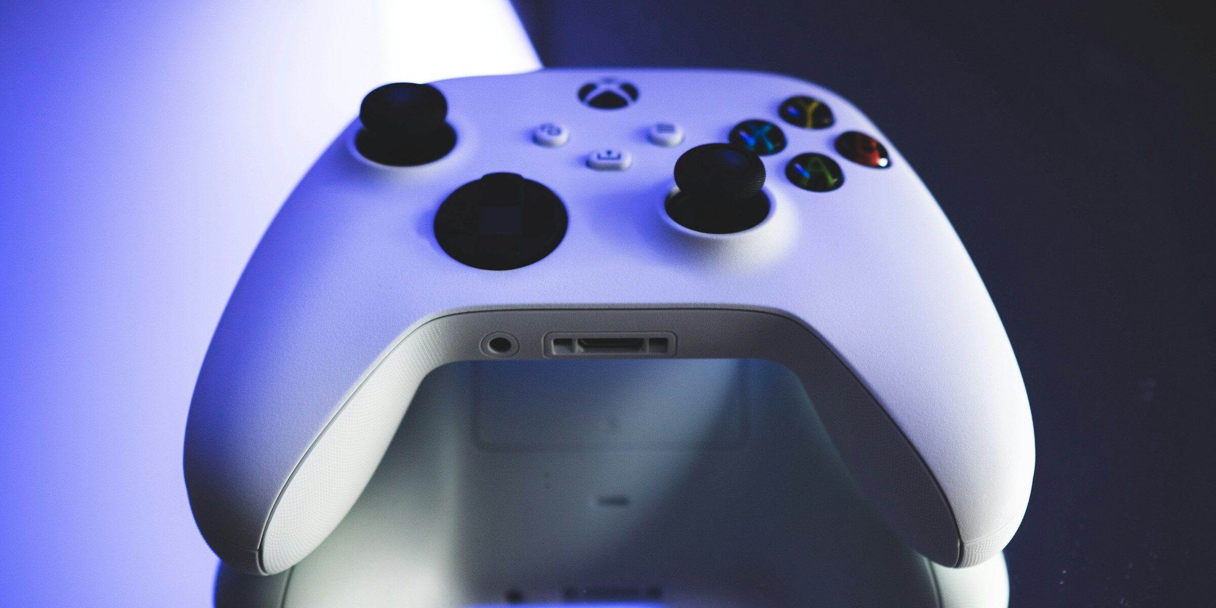 White Xbox controller sitting on reflective table top