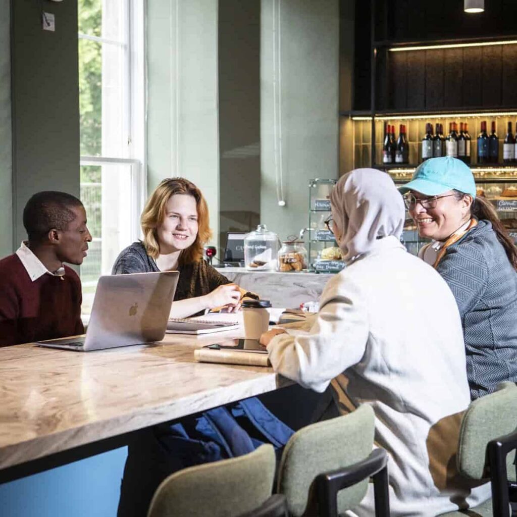 A group of students sitting round a table in the cafe