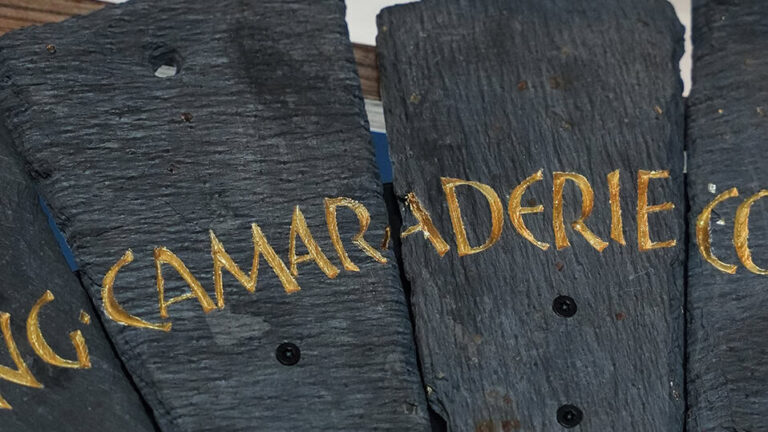 Slate from the Spirit Case sculpture displaying the words 'camaraderie'