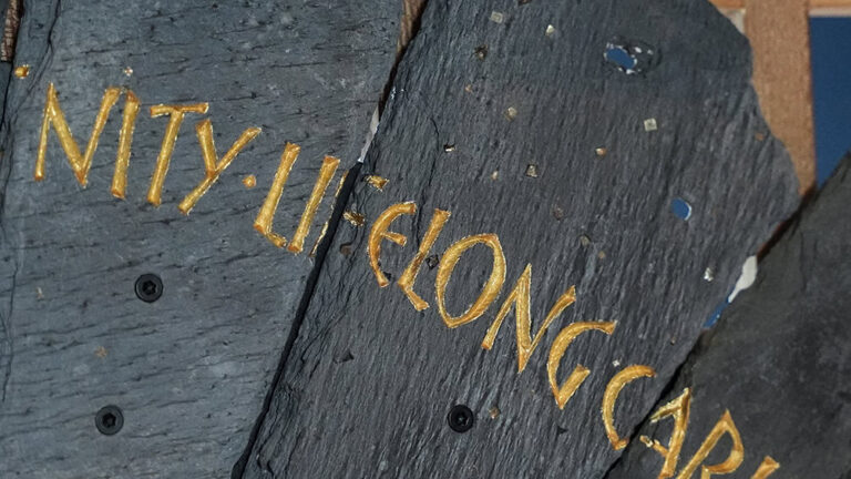 Slate from the Spirit Case sculpture displaying the words 'lifelong'