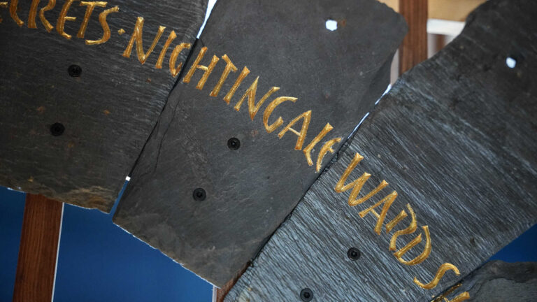 Slate from the Spirit Case sculpture displaying the words 'nightingale ward'