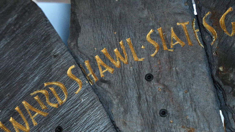 Slate from the Spirit Case sculpture displaying the words 'shawl'