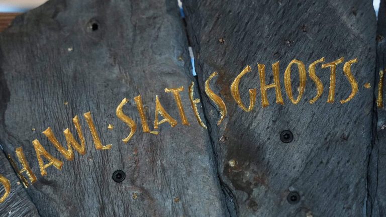 Slate from the Spirit Case sculpture displaying the words 'slates'