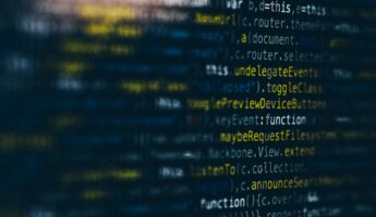 A close-up of a computer screen displaying colorful, highlighted lines of programming code on a dark background. The code includes words like "function," "toggle," and "RequestFiles.